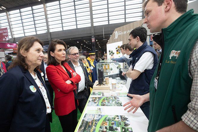 Lydie Bernard et Christelle Morançais devant un stand, écoutent un agriculteur, au Salon de l'agriculture